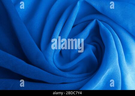 Classic blue delicate fabric draped and spun. Closeup. Stock Photo