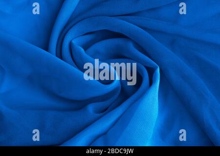 Classic blue delicate fabric draped and spun. Closeup. Stock Photo
