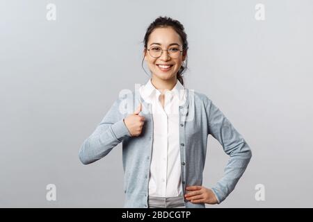 Advertisement, education and people concept. Cheerful, confident and satisfied smiling asian woman recommend product, advice try company service Stock Photo