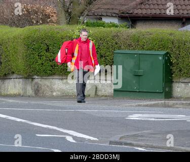 Glasgow, Scotland, UK, 8th April, 2020: Coronavirus saw deserted streets and Empty roads as people exercised on the Forth and Clyde canal. As the postman is practising distance with post left at the gate. Gerard Ferry/ Alamy Live News Stock Photo