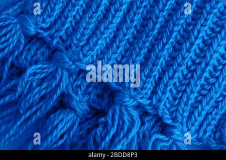 A fragment of a woolen scarf. The concept of care and warmth. Close-up. Stock Photo
