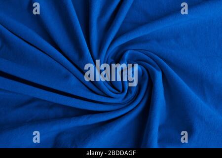 Classic blue delicate fabric draped and spun. Closeup. Stock Photo