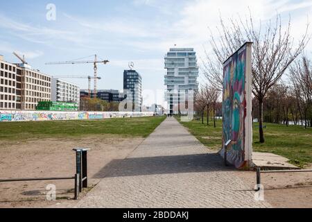 04.04.2019, Berlin, Berlin, Germany - Wall strip at the East Side-Gallery in Muehlenstrasse in Berlin-Friedrichshain, in the background the new office Stock Photo