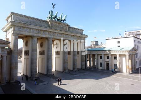 17.03.2020, Berlin, Berlin, Germany - Effects of the corona virus: Only a few people in front of the Brandenburg Gate on Pariser Platz. 00S200317D626C Stock Photo