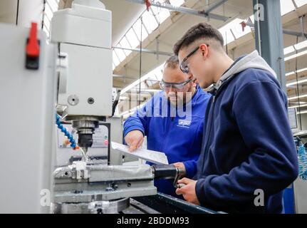 12.02.2020, Remscheid, North Rhine-Westphalia, Germany - Trainees in metal professions, here with a trainer at a machine tool, vocational training cen Stock Photo