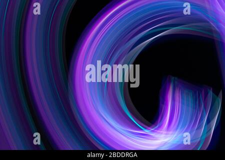 multi colored colorful neon light painting long exposure, defocused blurred. ripples and waves black background. Stock Photo