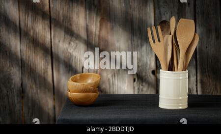 Wooden table in the kitchen with space for product montage. Nice pleasant kitchen interior with kitchen accessories background. Stock Photo