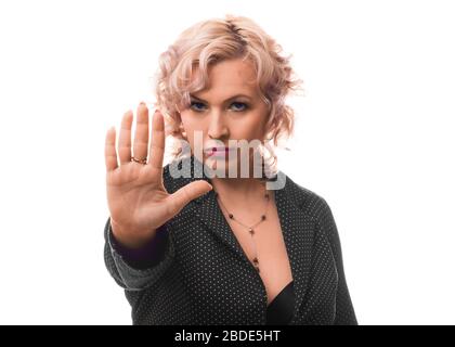 Middle aged businesswoman showing stop sign with palm of hand. Isolated on white background. Stock Photo