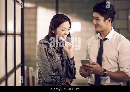 young asian entrepreneurs businessman and businesswoman having a conversation in office Stock Photo
