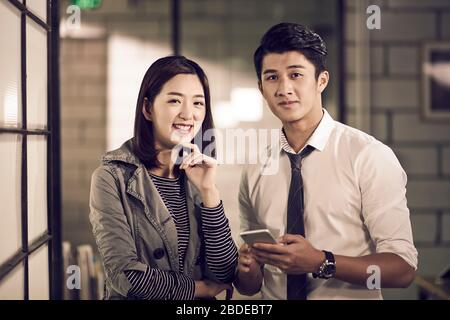 portrait of young asian entrepreneurs businessman and businesswoman looking at camera smiling Stock Photo
