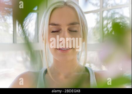 Portrait of young blonde woman with eyes closed Stock Photo