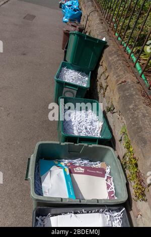 Bristol-April-2020-England-a close up view of a line of recycling paper conrtainers waiting to be collected Stock Photo