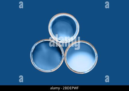 Color of the 2020 year. Three cans are filled paint of classic blue color on classic blue background. Copy space for your text. Stock Photo