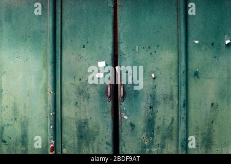 Closed old rusty metal green door background Stock Photo