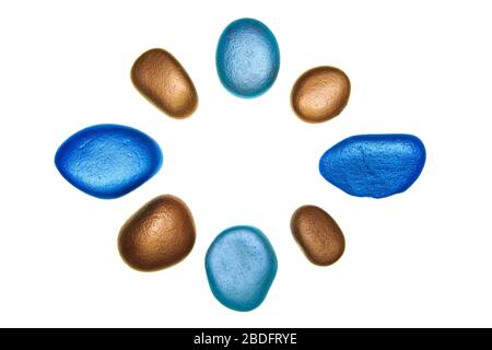 Group of multi coloured painted stones isolated on a white background Stock Photo