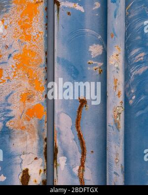Detail of peeling paint and markings on colorfully painted industrial cargo container Stock Photo