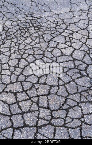 Detail of cracked and fractured asphalt road surface Stock Photo