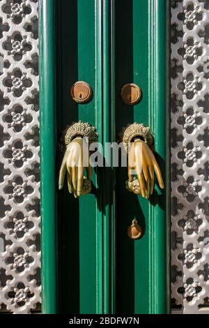 Door knockers in the form of hands, Algarve, Portugal Stock Photo