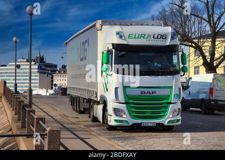 Green and white DAF XF semi trailer of Euro-Log Logistics from Hungary exits Port of Helsinki, Finland on beautiful day of spring. April 7, 2020. Stock Photo
