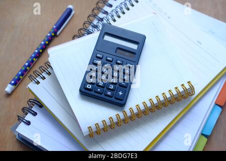 high angle view of stack of diary and calculator table. Stock Photo