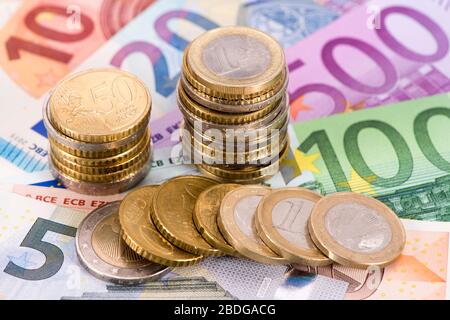 heap of banknotes of Euo currency with coins Stock Photo