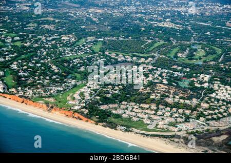 Aerial view of tourist resorts on the Algarve coast of Portugal with Praia de Vale Do Lobo, Quarteira and Praia do Garrao Poente visible. Stock Photo