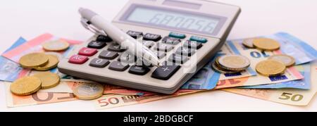 heap of banknotes of Euo currency with coins and calculator Stock Photo