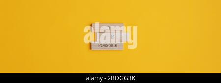 It is possible sign on stacked wooden pegs placed over yellow background. Wide view image with copy space. Stock Photo