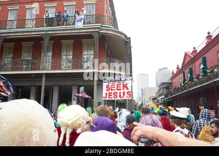 St Ann parade on Mardi Gras in French Quarter, with protesters in background. Stock Photo