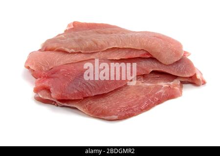 Turkey escalope on wooden plate against white background Stock Photo