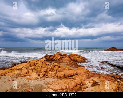 Beach with red porphyry rocks in the immense Mediterranean scrub of Ogliastra, Sardinia, Italy Stock Photo