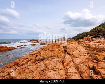 Beach with red porphyry rocks in the immense Mediterranean scrub of Ogliastra, Sardinia, Italy Stock Photo