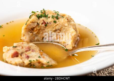 single speckknoedel in soup on wood Stock Photo
