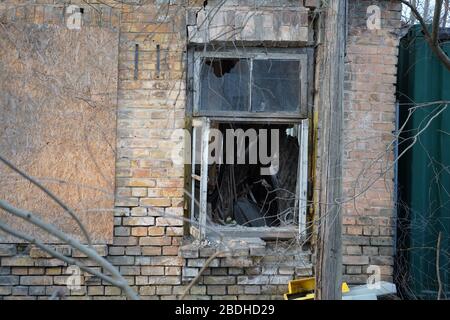 Broken window in old abandoned building Stock Photo