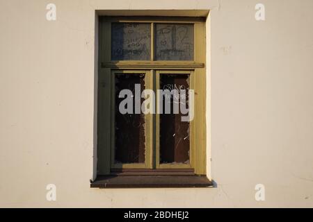 Old window with broken glass in not so old building Stock Photo
