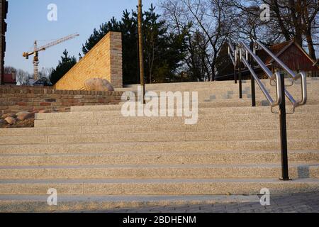 New stairs and fence from old bricks int he background. Huge crane in the background. Stock Photo