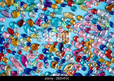 colored rhinestones on a turquoise background, color texture Stock ...