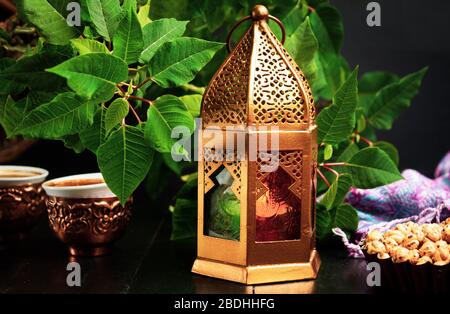 Dates served with coffee in Arabic style arrangement on a table Stock Photo