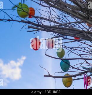 Beautiful and colorful easter egg decoration hanging in a tree Stock Photo