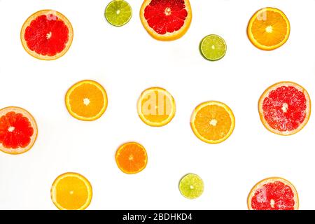 Creative sample of lime, orange and grapefruit. flat lay. Food concept. Lime, orange and grapefruit on a white background. Flat layout. Stock Photo