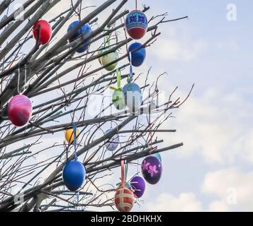 Beautiful and colorful easter egg decoration hanging in a tree Stock Photo
