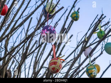 Beautiful and colorful easter egg decoration hanging in a tree Stock Photo