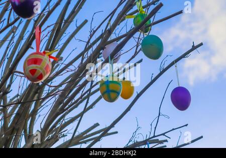 Beautiful and colorful easter egg decoration hanging in a tree Stock Photo