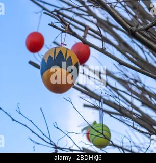 Beautiful and colorful easter egg decoration hanging in a tree Stock Photo
