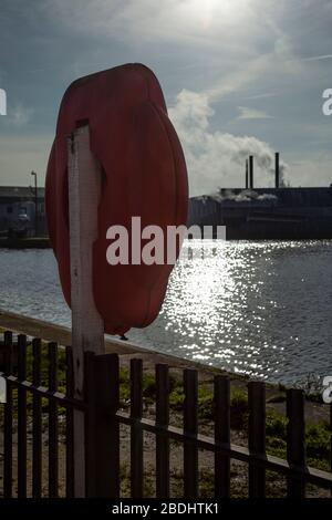 Red lifebuoy in bright sun light. Stock Photo