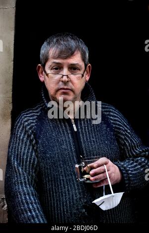 A supermarket worker takes a coffee break during lockdown, Barcelona, Spain. Stock Photo