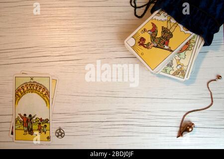 Top view of tarot cards, pentacle and pendulum on white wooden board Stock Photo