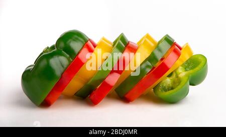 Whole paprika of sliced red, green, yellow bell pepper section Stock Photo