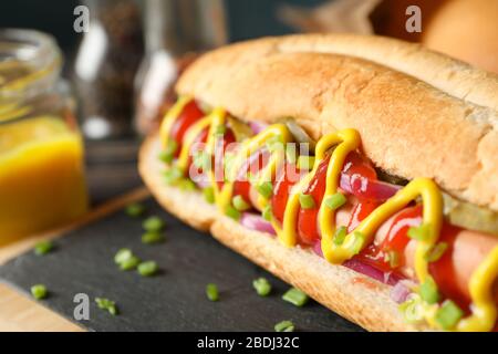 Tasty hot dog on cutting board, close up Stock Photo