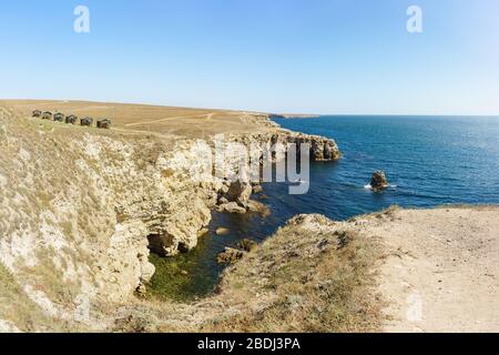 Fishing houses on Bolshoy Atlesh Cape in Crimea. Sunny day. Tarhankut Stock Photo